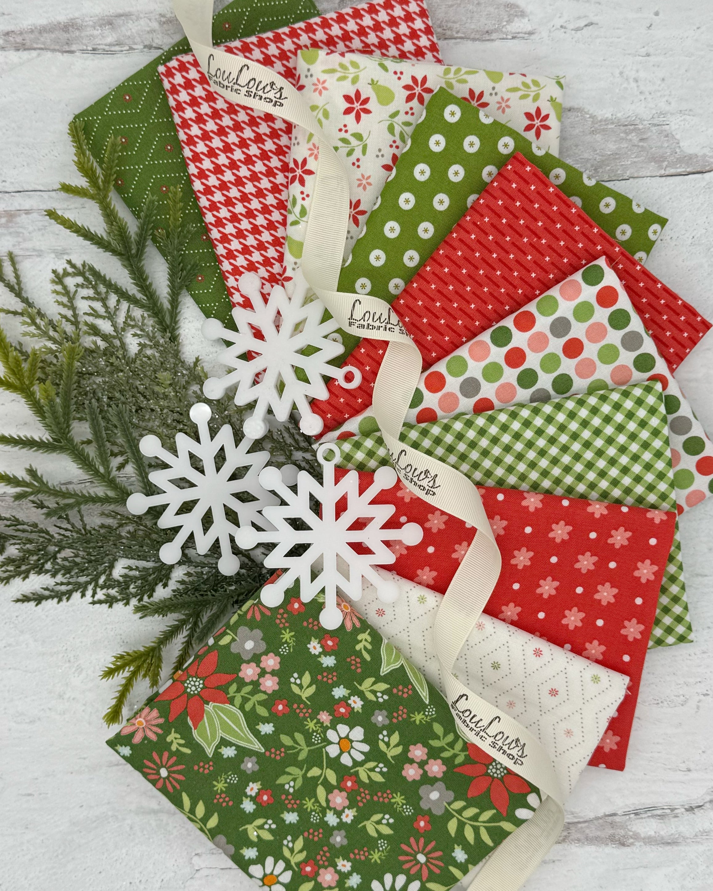 Collection of Christmas inspired prints with bright reds, greens and off whites. 10 fat quarters