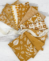 10 mustard/honey colored fat quarters with mostly with a floral or botanical print. 