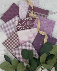 Collection of 10 fat quarters in shades of lavender and plums. Florals, ginghams and plaids. 