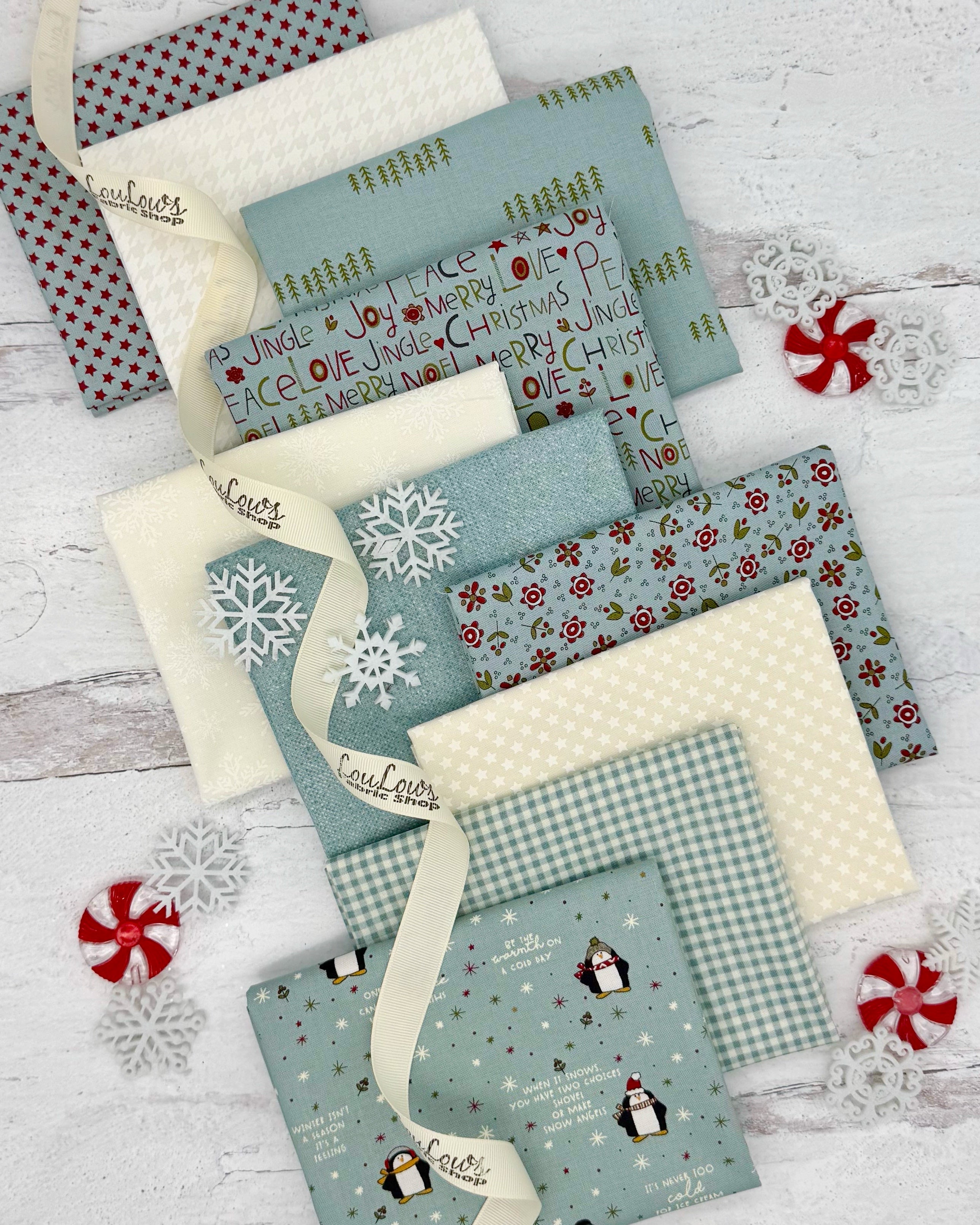 Collection of 10 fat quarters- 7 in a calming, soft blue and 3 creamy whites, all with a winter feel. 