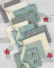 Collection of 10 fat quarters- 7 in a calming, soft blue and 3 creamy whites, all with a winter feel. 