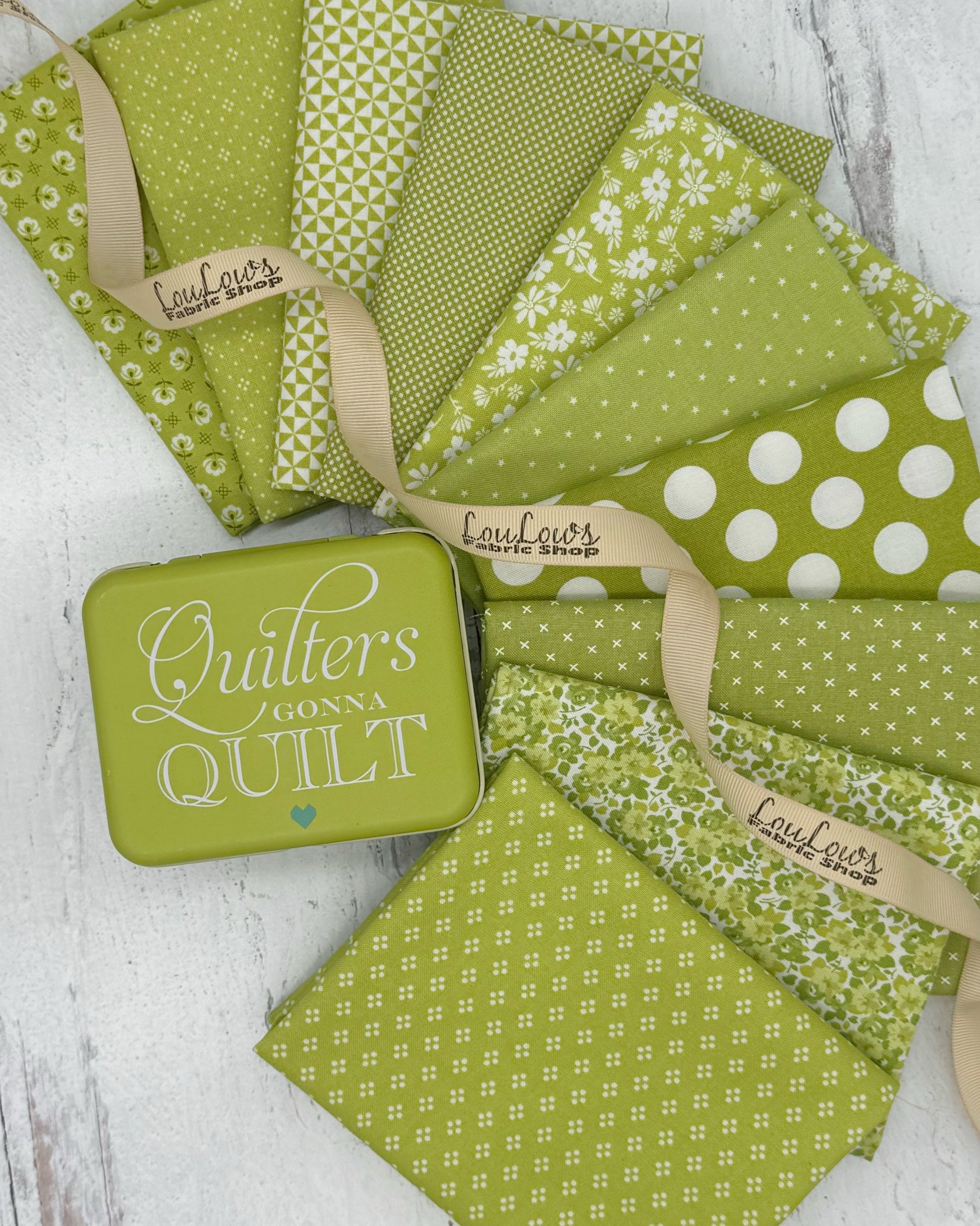 Collection of 10 fat quarters in a chartreuse green color with a variety of floral, dot and geometric prints. 