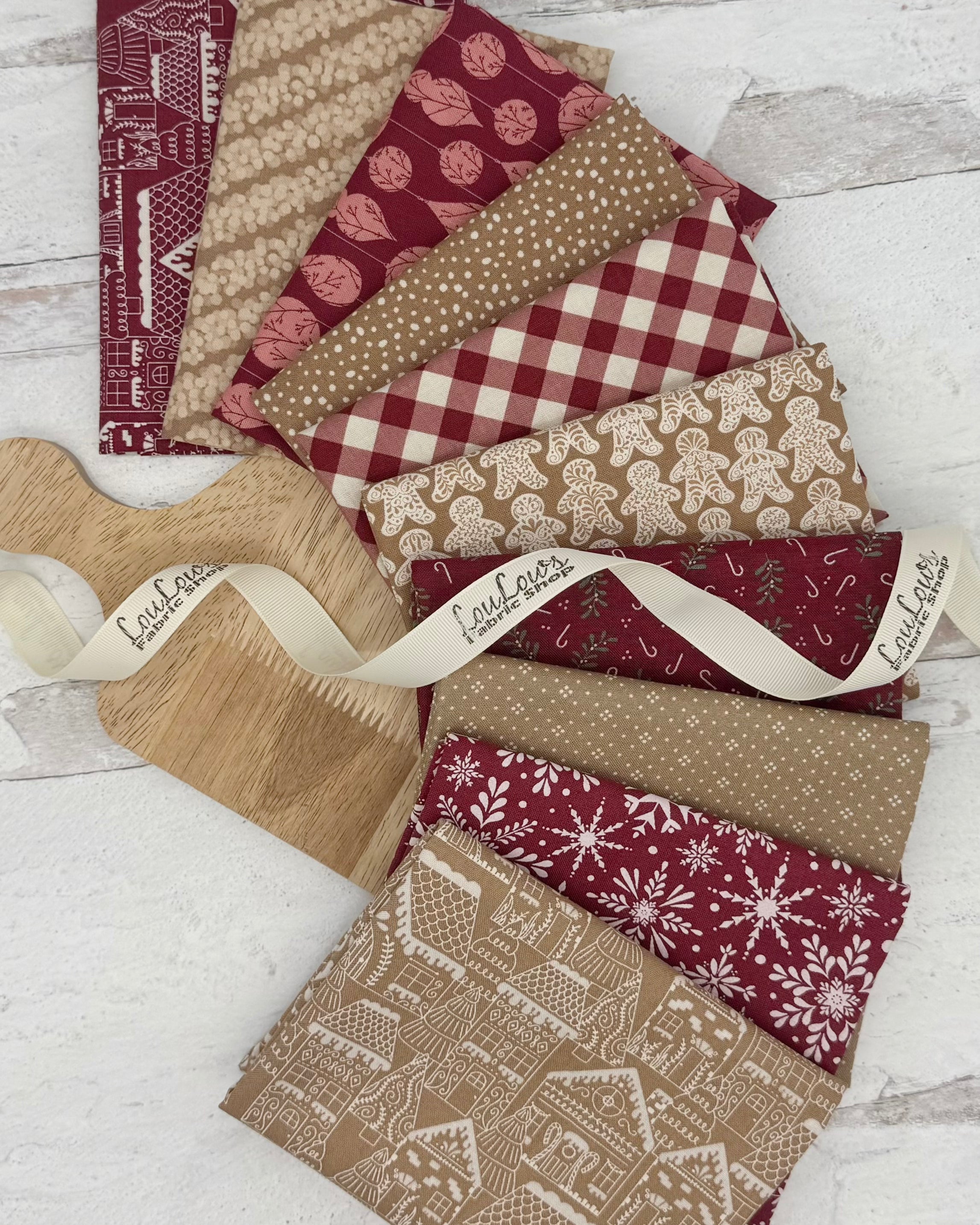 10 fat quarters- 5 with a gingerbread color background and 5 with a mulberry colored background with gingerbread men and winter prints. 