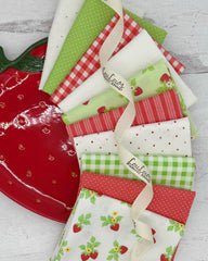 10 fat quarters with off white, dark pink and lime green backgrounds. Featuring strawberries, ginghams, stripes and dues. 