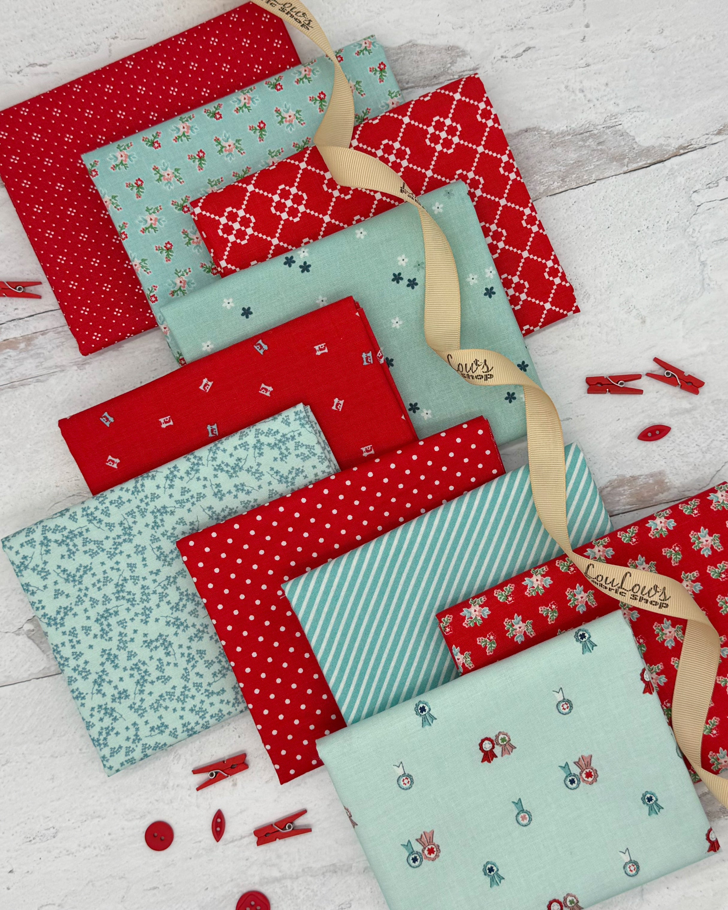 10 fat quarters, 5 cherry red and 5 aqua blue in a variety of prints from stripes to dots to florals. 