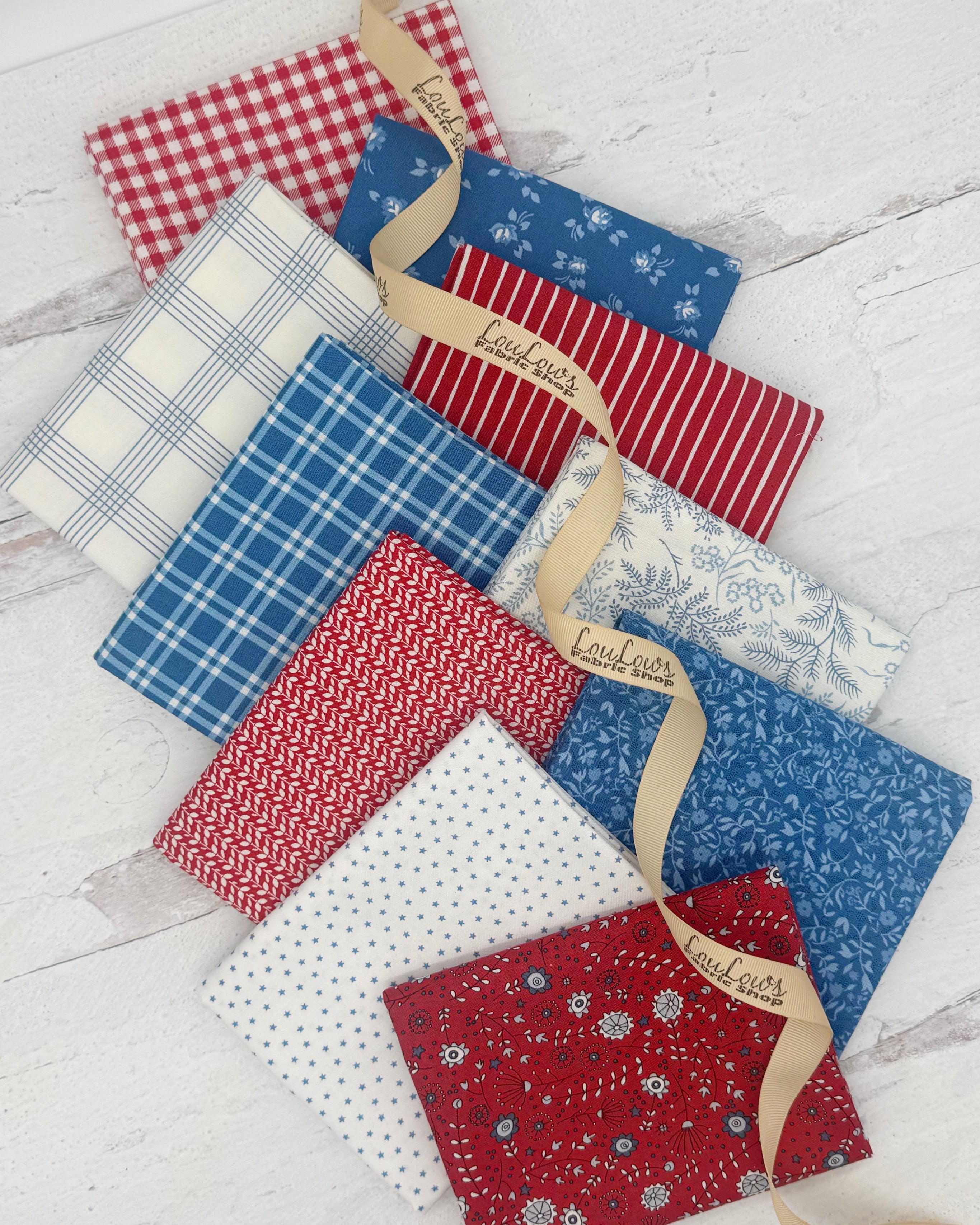 10 fat quarters in red, white and blues. Fabrics have florals, plaids, ginghams and stripes. 