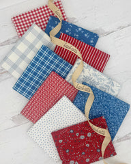 10 fat quarters in red, white and blues. Fabrics have florals, plaids, ginghams and stripes. 