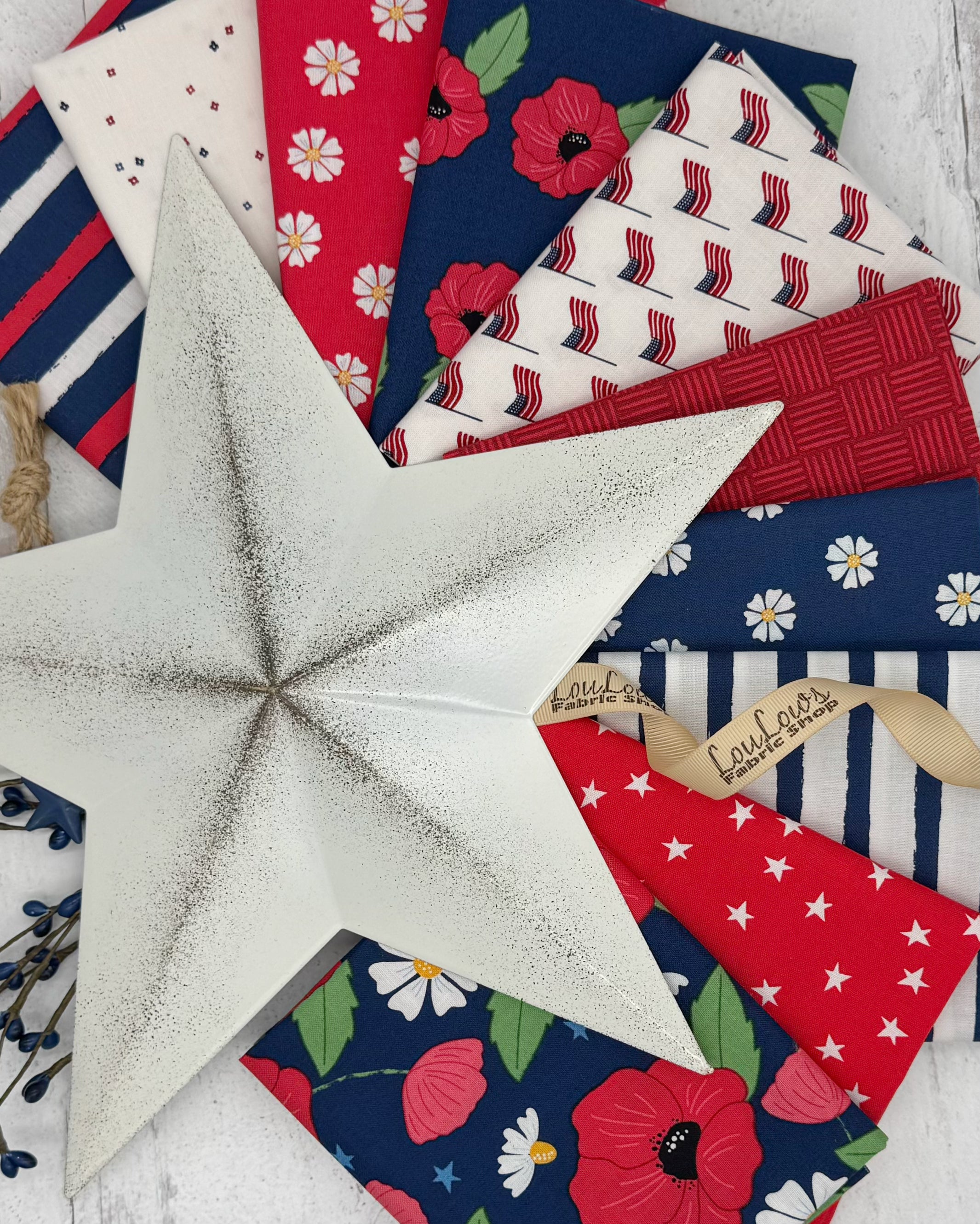 Connection of 10 fat quarters in reds, whites and navies with an island feel. 