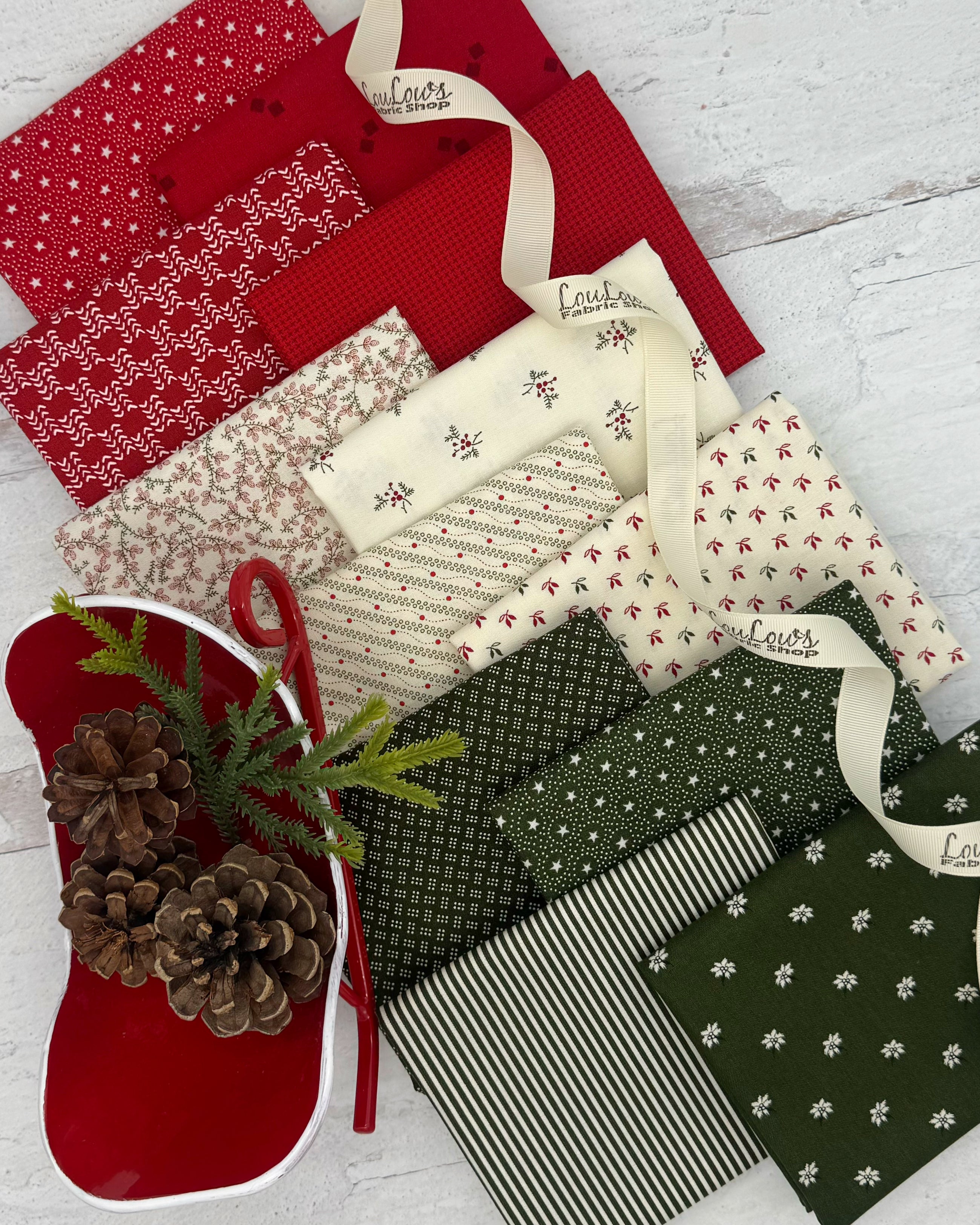 Collection of 12 fat quarters. 4 of each cream, deep red and evergreen, all with a low volume Christmas feel. 