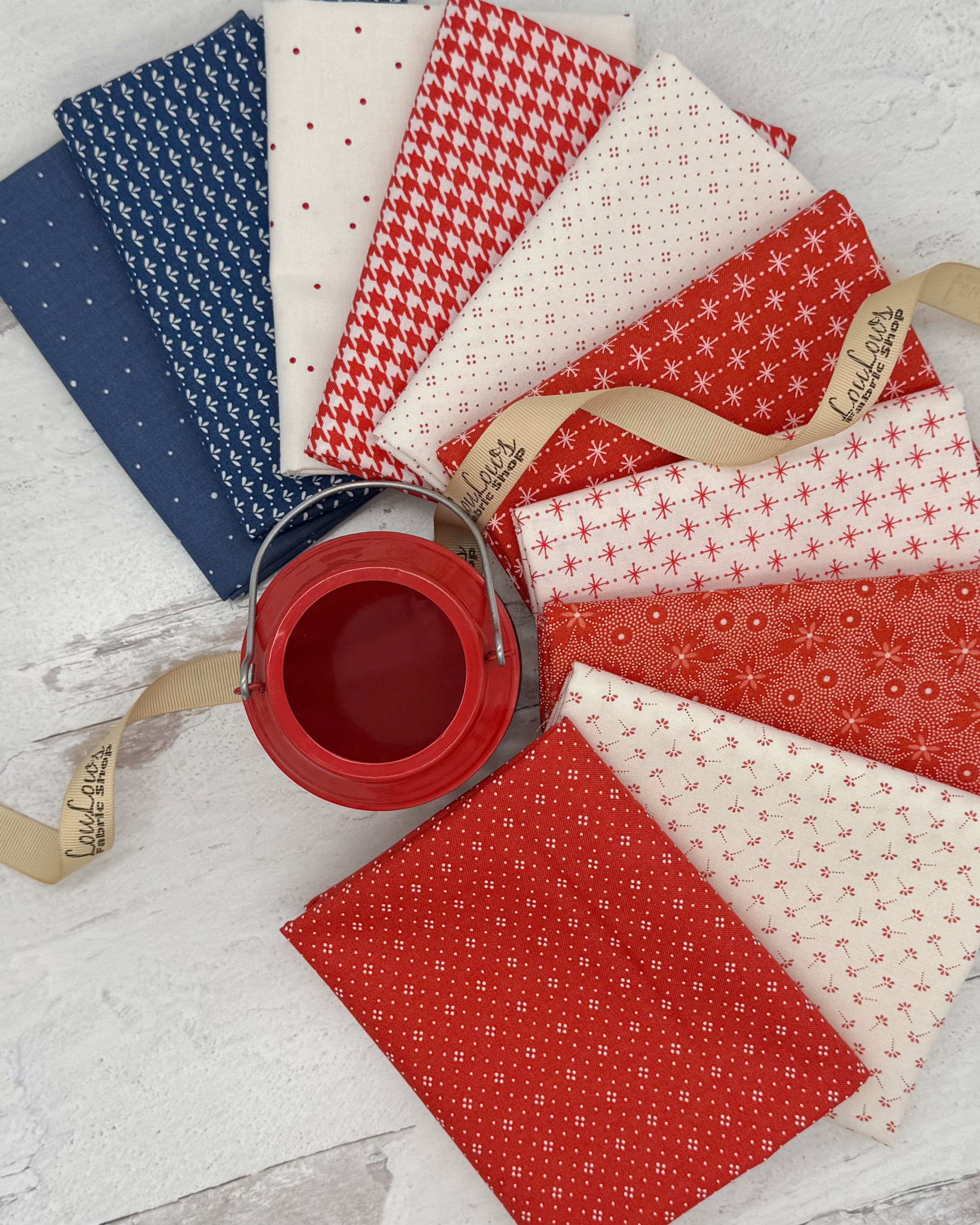 10 fat quarters- 2 blue, 4 red and 4 off white with small red details. 