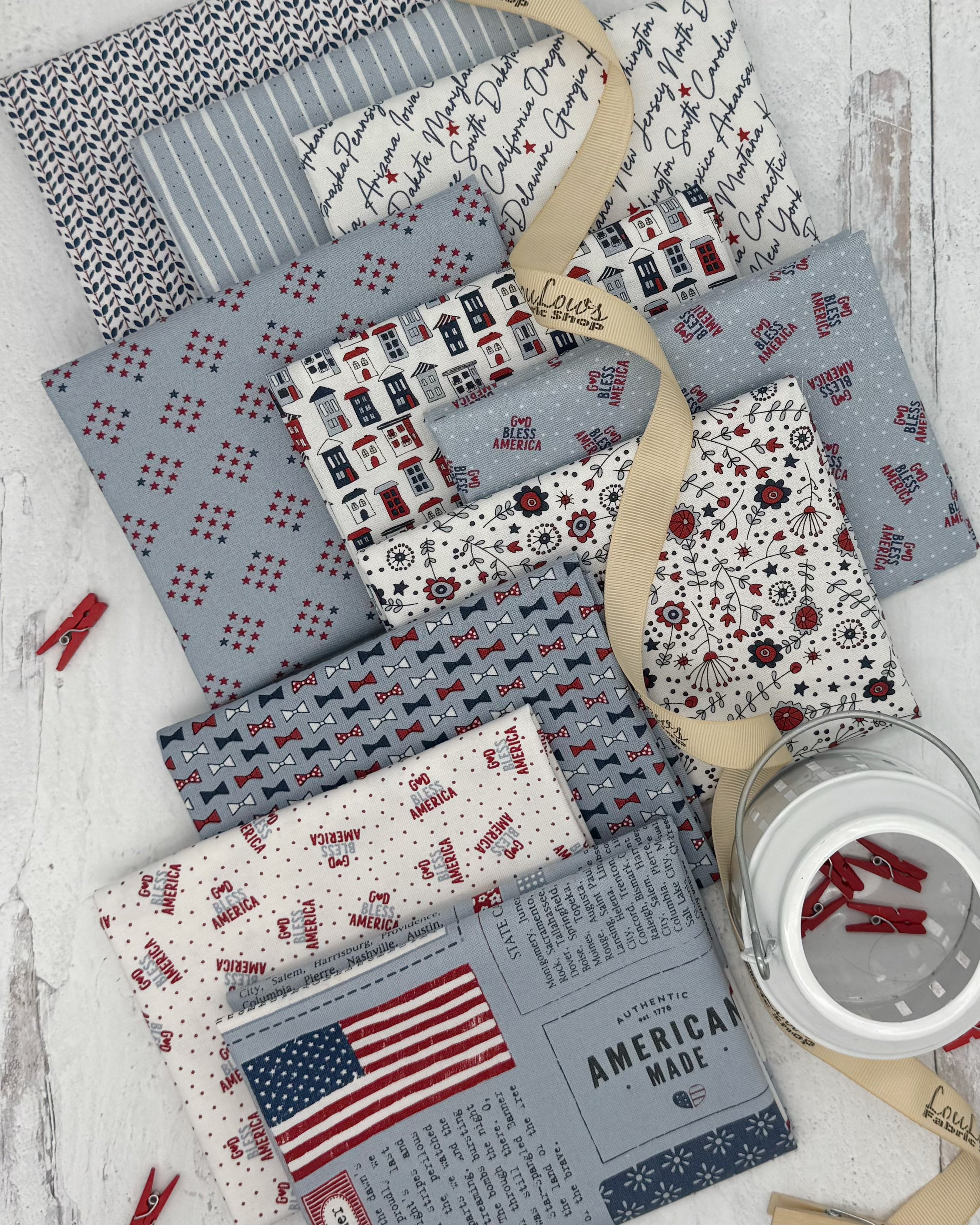 Collection of 10 fat quarters with soft blue and off white backgrounds. All with patriotic themes. 