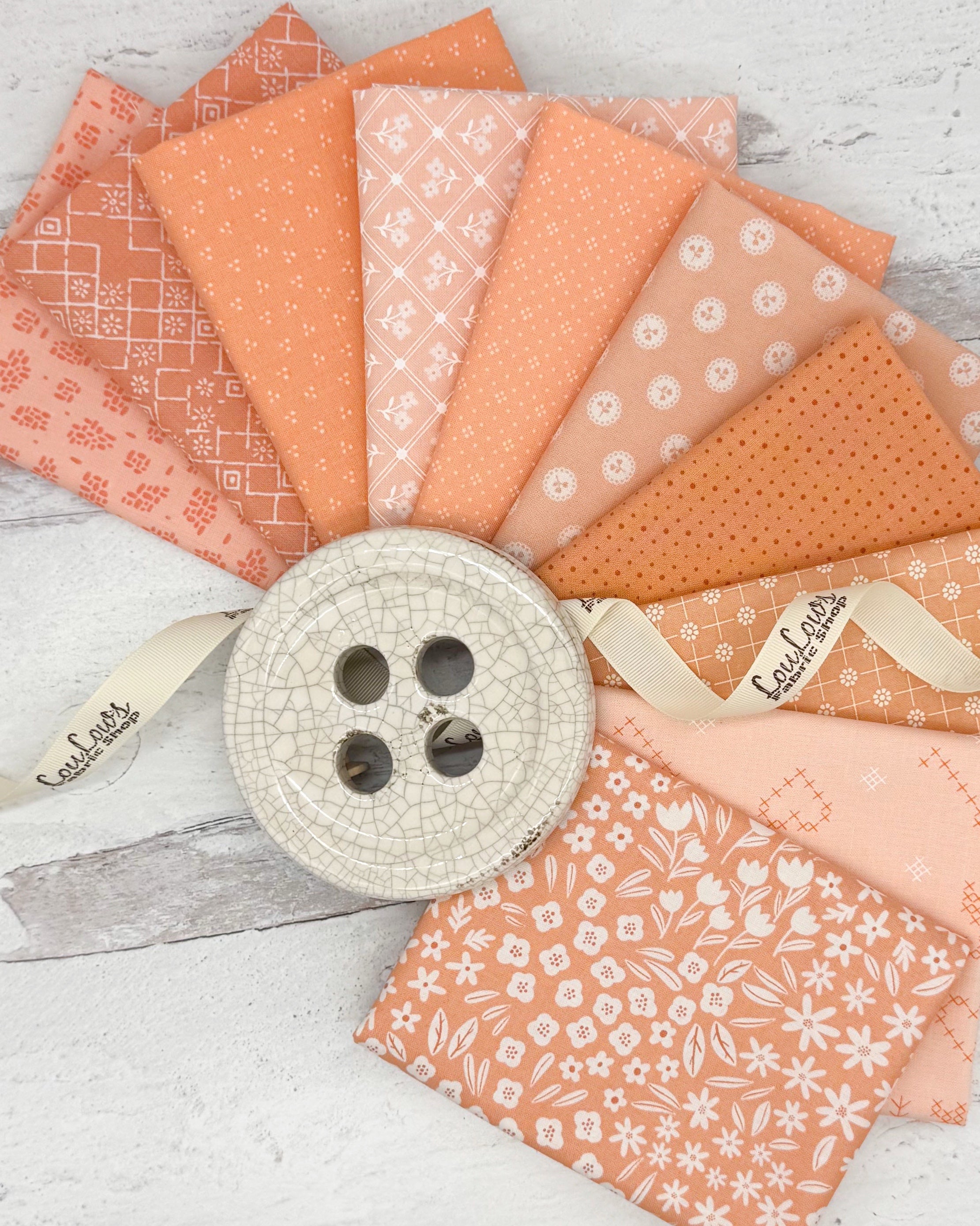 10 fat quarters in a variety of peachy and salmon colors with geometrics, florals and dots. 