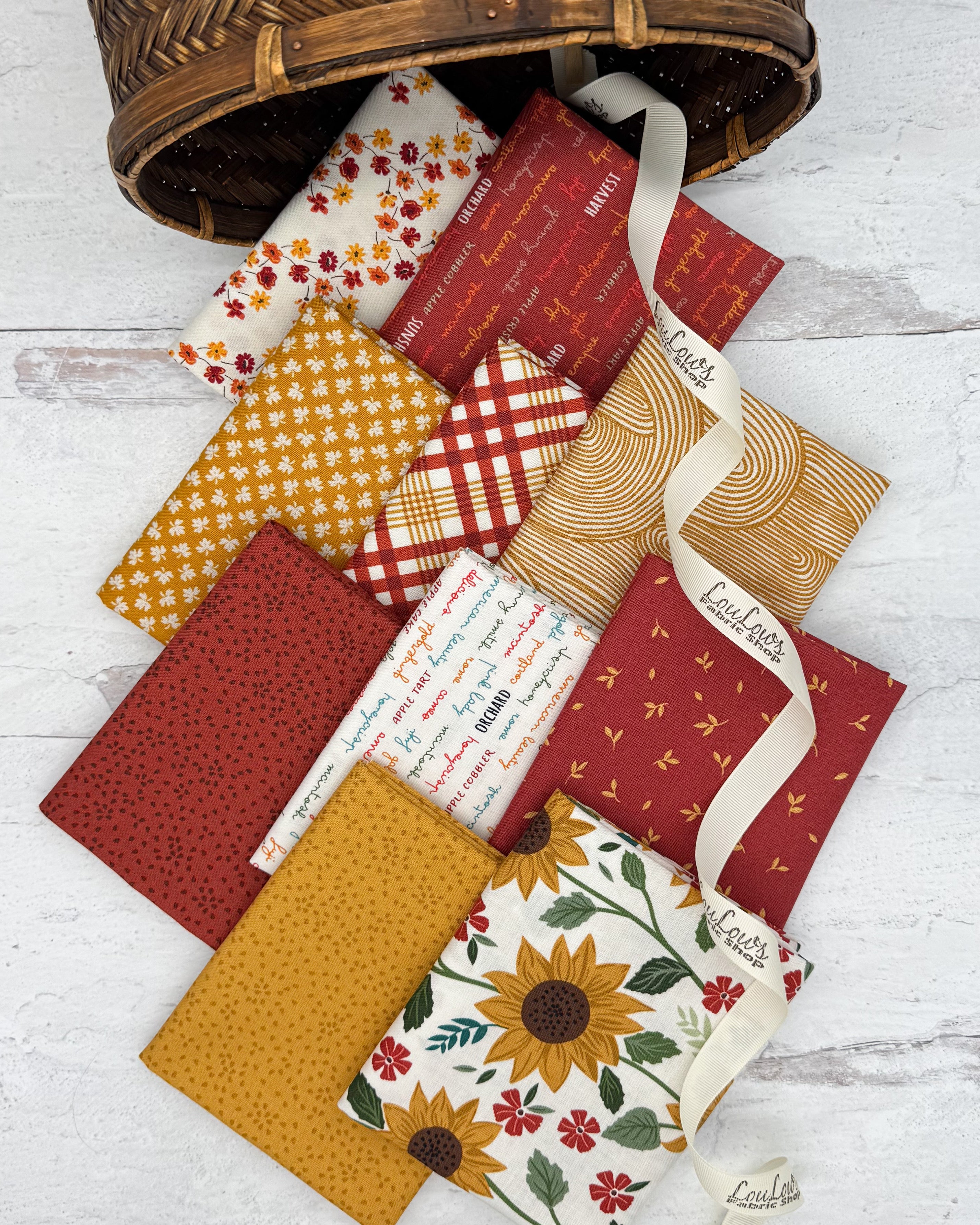 10 fat quarters in off white, rust and golden backgrounds with sunflower, seeds, plaid and fall prints. 