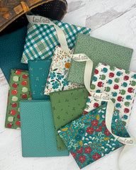 Collection of 10 fat quarters in a deep teal, fresh green and white backgrounds. Prints include apples, seeds, florals and geometrics. 
