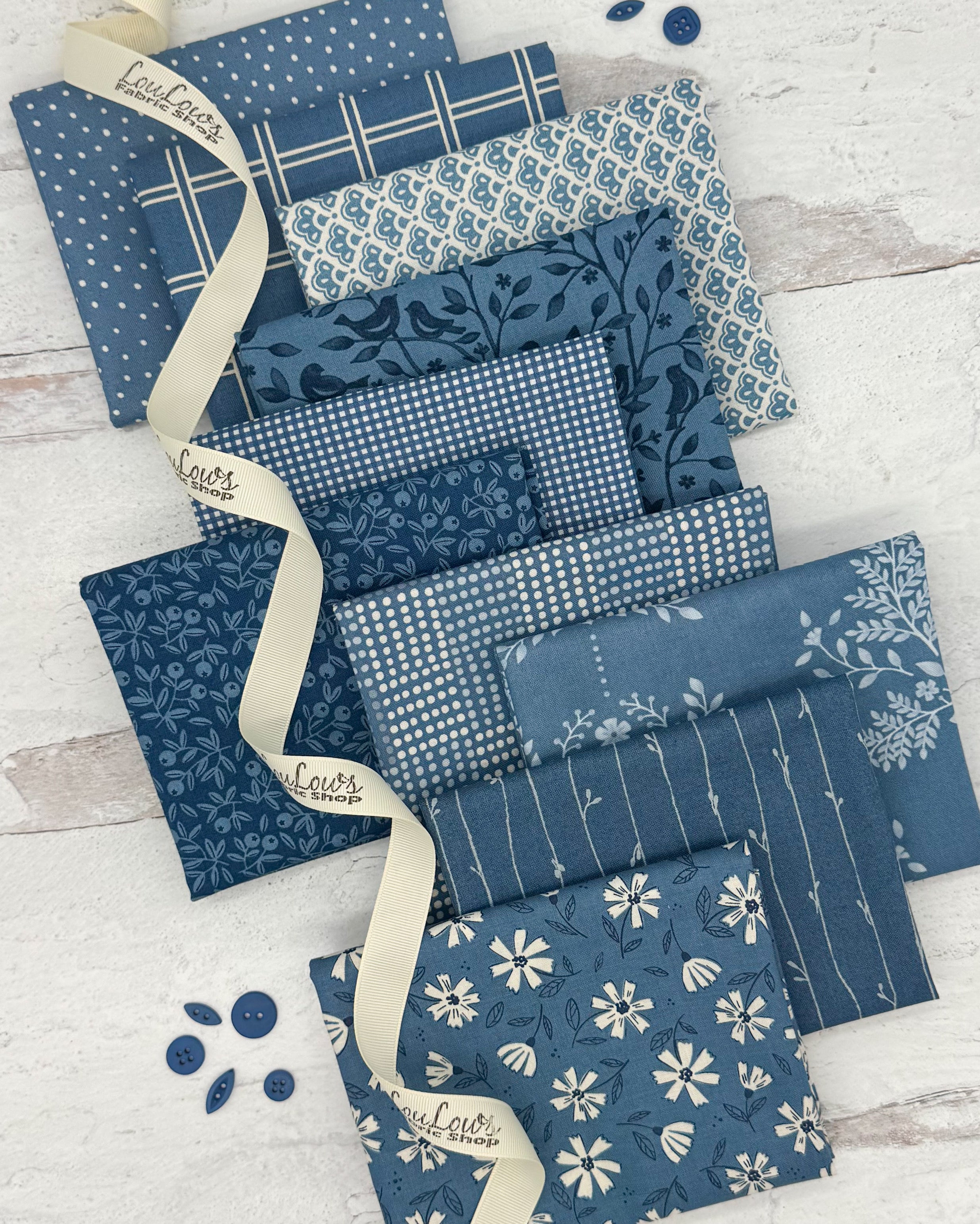 10 fat quarters in a denim blue color with floral, dot and geometric prints. 