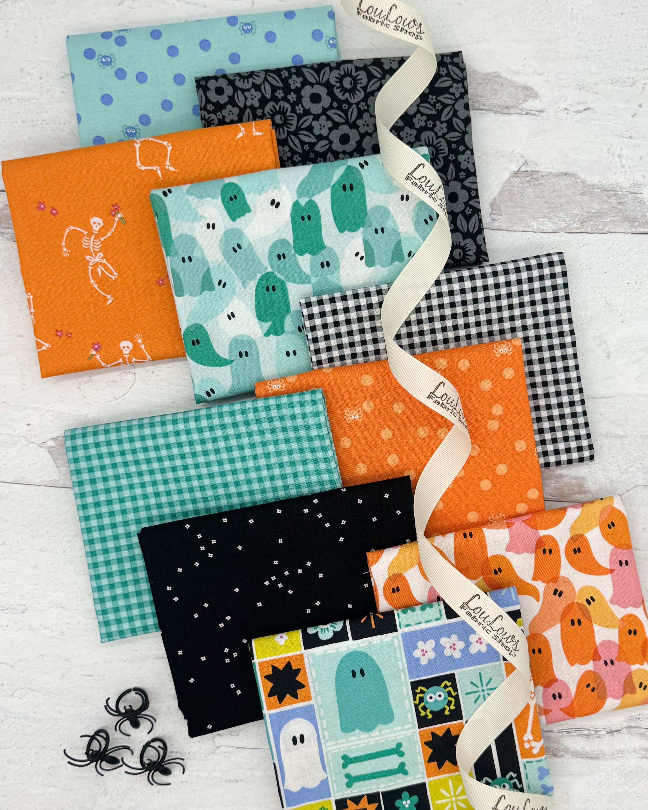 10 fat quarters in blacks, bright oranges and teals. Prints vary from ginghams, ghosts and skeletons. 