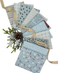 10 fat quarters in fun holiday prints in a light winter blue 